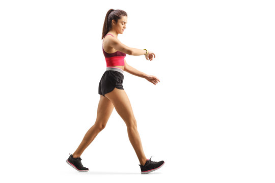 Fit young woman walking checking her sports arm-band © Ljupco Smokovski