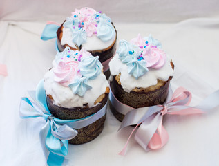 Traditional slavic orthodox easter cake named kulich with white icing, meringue decoration and festive ribbons