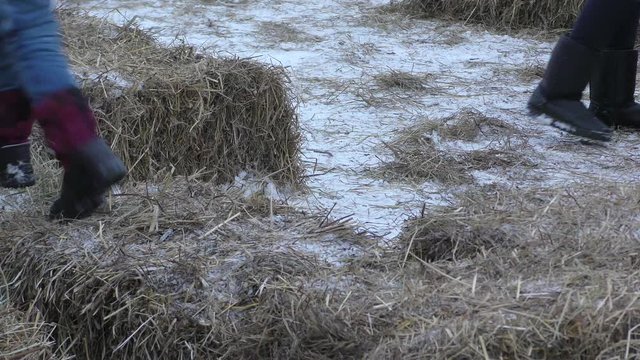 Children play on the playground with hay at Maslenitsa holiday. Moscow, Russia.