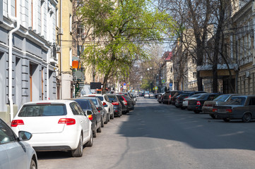 parked cars in the city center on a one-way street. parking problem in big cities. business center