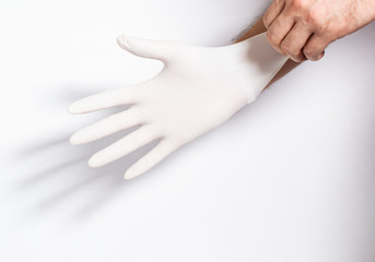 Person putting on surgical latex gloves