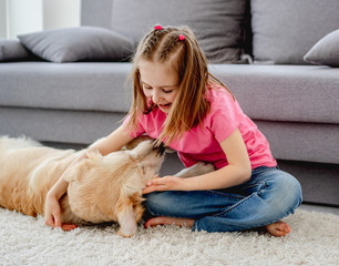 Obraz na płótnie Canvas Girl playing with dog at home