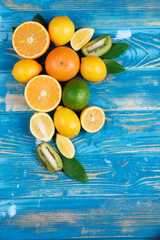 The composition of fruit on a lue wooden background.