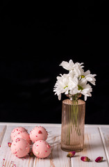 Pink cake pops in a jar of sugar in the form of a bouquet on a wooden background.