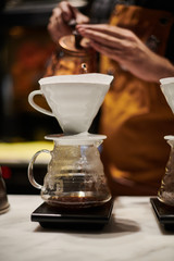 Barista at work, brewing special brew coffee at third wave cafe