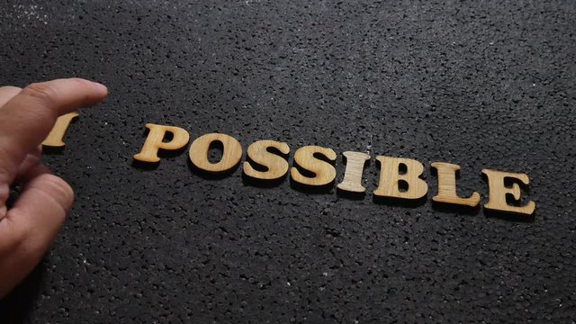Impossible to Possible, business motivational inspirational quotes; wooden words typography lettering concept