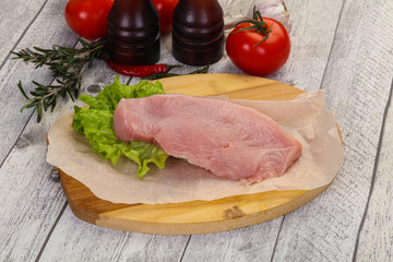 Raw Turkey steak served rosemary