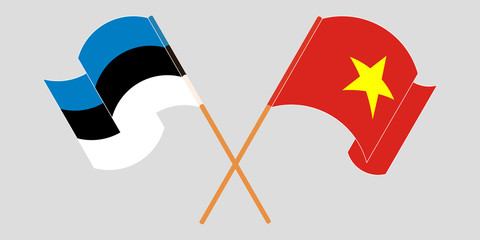 Crossed and waving flags of Estonia and Vietnam