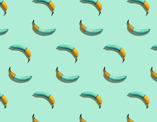 Seamless texture of bananas wearing condom on a blue background with hard shadows