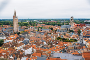 Fototapeta premium Panoramic view from the Belfort tower on the historic part of Bruges and the Cathedral of St. Salvator, the main pedestrian street with many shops, Belgium. Travel to Belgium.