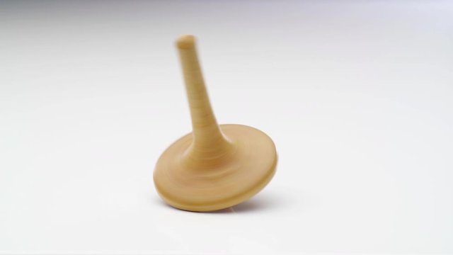 Wooden spinning top moving. Close up shot. 