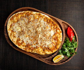 lahmajun with stuffed meat and cream cheese on a wooden bowl
