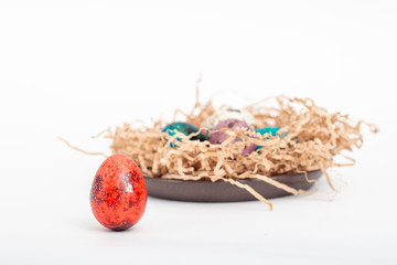 Multi-colored quail eggs for Easter in the filler