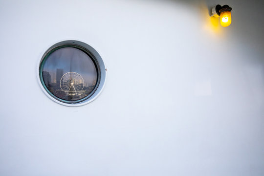 The reflection of the Seattle waterfront in the window of a ferry sailing across the Puget Sound.