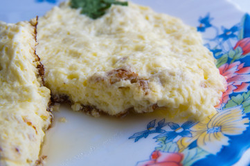 hot omelet on a colorful plate on a white background