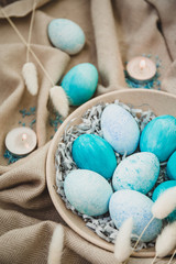 Easter painted blue eggs. Happy Easter card. Top view, flatlay. Easter bunny rabbits. Pastel background