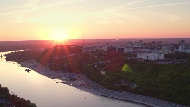 Ufa city aerial view to Monument to Salavat Yulaev and Cultural center of the city at beautiful sunset at background through Belaya river in Bashkortostan