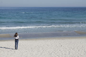 Lonely girl on a background of the sea