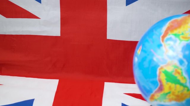 Globe with UK flag in background. British Commonwealth of Nations