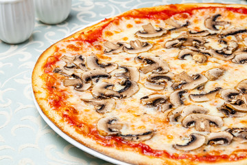 pizza with mushrooms on white plate