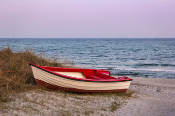 Naklejka na ściany i meble View of a small boat, on the beach of the Baltic Sea near Trelleborg, Sweden.