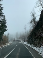 Driving empty mountain road at winter