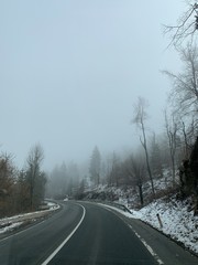 Obraz na płótnie Canvas Driving empty mountain road at winter