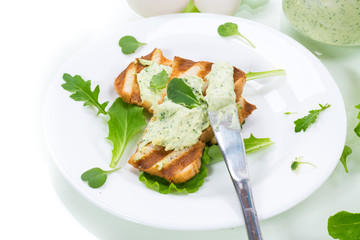 green bread spread of arugula, curds and eggs with fried toast