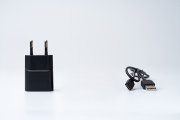 Black USB power adapter and cable for divice isolated on a white background.