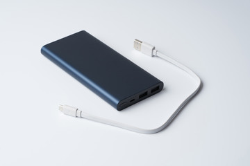 White USB cable and blue power bank for divice isolated on a white background.