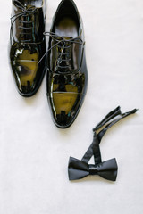 Groom shoes and bow tie. Preparations for the wedding day.