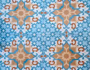 Fototapeta na wymiar Turquoise and orange ornamental floor tiles 
