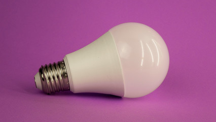 white light bulb on a purple background