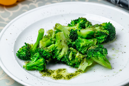 Broccoli In Garlic Sauce On White Plate