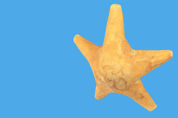 Handmade star made of wood isolated on a blue background