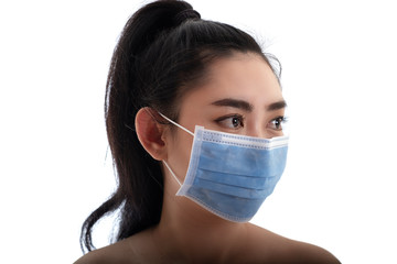 Beautiful young Asia woman putting on a medical mask to protect from airborne respiratory diseases as the flu covid-19 PM2.5 dust and smog, Women safety virus infection concept