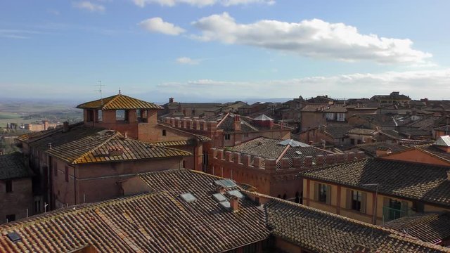 Panorama of the roofs of houses of ancient Siena in Tuscany, Italy Sunny warm winter day.