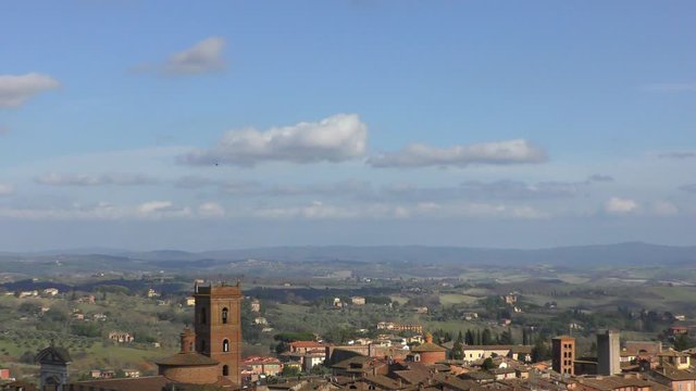 The view from the heights of the rooftops of ancient Siena and the beautiful hills in the surrounding area. Tuscany, Italy.