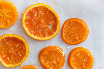 Fototapeta na wymiar Candied orange slices on parchment paper