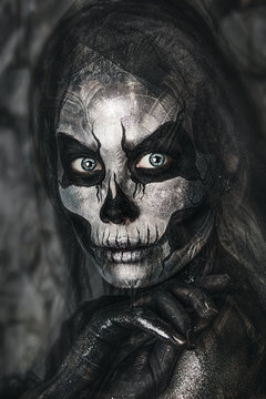 close up portrait of girl with professional Halloween skull makeup. Black veil