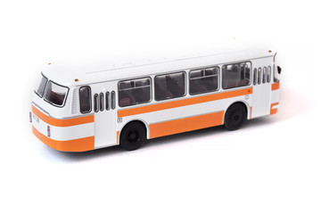 Fototapeta na wymiar Scale model of a white yellow Russian bus. Toy yellow bus
