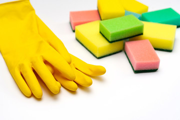 yellow rubber gloves and washcloths on a white background