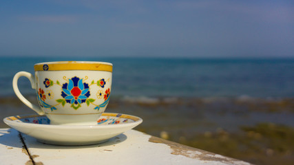 Hot Turkish coffee on the beach wooden table. Relaxation mood, resting vacation. Leisure in sunny summer day. Beautiful low view of life with pleasure. 