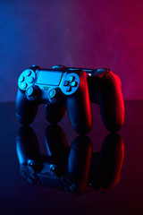 Game controller, videogame joystick or gamepad on a table. Close up studio shot. Game concept