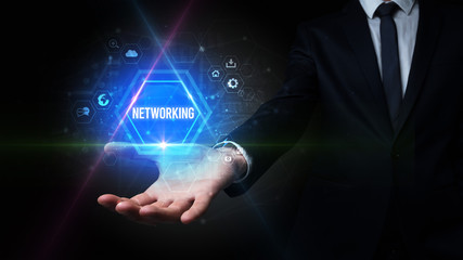 Naklejka premium Man hand holding NETWORKING inscription, social media concept