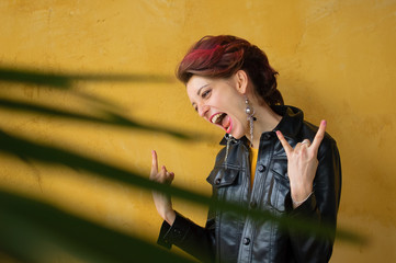 Let's rock concept. Portrait of excited beautiful woman with dark pink hair in casual yellow dress...
