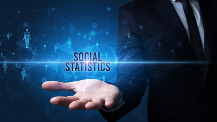 Elegant hand holding SOCIAL STATISTICS inscription, social networking concept