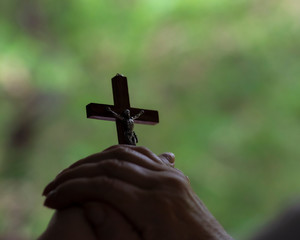 hand holding a wooden cross, easter