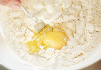 step by step visual instruction, ingredients to prepare quiche tart dough. Homemade quiche with salmon and cheese. step 1, mixing flour, eggs, butter and sour cream