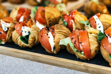 Sandwiches with herbs and vegetables on a wooden tray